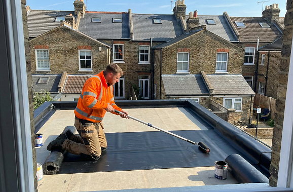 Professional flat roof installation in progress showing EPDM membrane application London